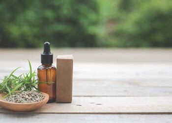 Cannabis, Cannabis seeds, Cannabis oil Placed on a wooden floor With a green tree background in the background.